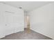 A bedroom features neutral carpeting, a closet and bright white walls at 225 Lazy Shore Dr, Nokomis, FL 34275