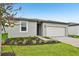 Single-story house featuring a manicured lawn with fresh landscaping at 225 Lazy Shore Dr, Nokomis, FL 34275