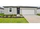 Charming single-story home featuring a well-maintained lawn, a single-car garage, and a beautifully landscaped front yard at 225 Lazy Shore Dr, Nokomis, FL 34275