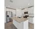 Bright kitchen features stainless steel appliances, white cabinets, and a granite island at 225 Lazy Shore Dr, Nokomis, FL 34275