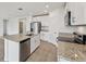 Bright kitchen features stainless steel appliances, white cabinets, and a granite island at 225 Lazy Shore Dr, Nokomis, FL 34275
