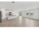 A spacious kitchen with a large island overlooks a bright living area and backyard at 225 Lazy Shore Dr, Nokomis, FL 34275