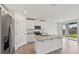 The kitchen features a large island, stainless steel appliances and granite countertops at 225 Lazy Shore Dr, Nokomis, FL 34275