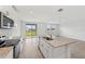 Bright kitchen features stainless steel appliances, white cabinets, and a granite island at 225 Lazy Shore Dr, Nokomis, FL 34275