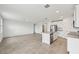 Bright open-concept living room and kitchen area with tile floors and neutral paint at 225 Lazy Shore Dr, Nokomis, FL 34275