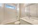 Bright bathroom featuring a combined shower and tub, toilet, and vanity with a sink and white walls at 14517 Coastal Woodland Ln, Parrish, FL 34219