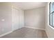 Cozy bedroom with closet and window, showcasing the neutral color palette at 14517 Coastal Woodland Ln, Parrish, FL 34219