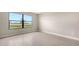 Bright bedroom showcasing a large window with tile flooring and neutral walls at 14517 Coastal Woodland Ln, Parrish, FL 34219