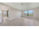 Spacious bedroom featuring large window with scenic views and tile flooring, creating a bright and airy feel at 14517 Coastal Woodland Ln, Parrish, FL 34219