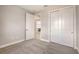 Simple carpeted bedroom with a closet and a door partially opened at 14517 Coastal Woodland Ln, Parrish, FL 34219