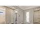 Neutral entryway with easy access to bathroom and bedroom, featuring a glass door letting in natural light at 14517 Coastal Woodland Ln, Parrish, FL 34219