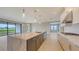 Spacious kitchen with an island, granite countertops, and seamless access to the outdoor space at 14517 Coastal Woodland Ln, Parrish, FL 34219