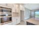 Bright kitchen with modern appliances, white cabinets, and an open view to the backyard at 14517 Coastal Woodland Ln, Parrish, FL 34219