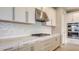 Beautiful kitchen featuring white cabinets, granite countertops, and stainless steel appliances at 14517 Coastal Woodland Ln, Parrish, FL 34219