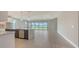 Bright open-concept living space offers seamless flow from the kitchen to the dining area and out to the backyard at 14517 Coastal Woodland Ln, Parrish, FL 34219