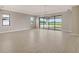 Spacious living room with tile flooring, large windows, and sliding glass doors to the outside at 14517 Coastal Woodland Ln, Parrish, FL 34219