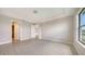 Bright main bedroom showcasing a large window with tile flooring, a walk-in closet, and an ensuite bathroom at 14517 Coastal Woodland Ln, Parrish, FL 34219