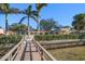 Backyard featuring private water access, lush landscaping, and meticulously maintained grounds at 103 Shore Dr, Dunedin, FL 34698