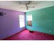 Bedroom with green and purple walls, two windows providing natural light, and carpeted flooring at 18316 Oxenham Ave, Spring Hill, FL 34610
