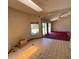 Bright living room with tile flooring, large windows, and a ceiling fan offering plenty of natural light at 18316 Oxenham Ave, Spring Hill, FL 34610