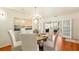 Bright dining room with hardwood floors, stylish chandelier, and elegant white chairs around a round table at 105 17Th Ne Ave, St Petersburg, FL 33704