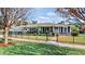 Inviting single-story home showcasing a lush front yard, enhanced by a decorative fence and mature trees at 105 17Th Ne Ave, St Petersburg, FL 33704