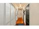 Hallway featuring hardwood floors, closet with louvered doors, and dark interior doors with satin hardware at 105 17Th Ne Ave, St Petersburg, FL 33704