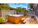 Wooden hot tub featuring brick paver and small stone landscaping with privacy fence at 105 17Th Ne Ave, St Petersburg, FL 33704