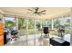 Bright sun room with large windows providing ample sunlight, a ceiling fan, and tile flooring at 105 17Th Ne Ave, St Petersburg, FL 33704