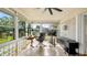 Bright sun room with large windows providing ample sunlight, brick accent wall, and tile flooring at 105 17Th Ne Ave, St Petersburg, FL 33704
