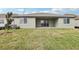 Spacious backyard featuring a patio, green grass and an AC unit at 1832 Draughton Dr, Zephyrhills, FL 33541