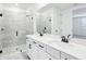 Bright bathroom with a double vanity, quartz counters, and a glass-enclosed walk-in shower at 1832 Draughton Dr, Zephyrhills, FL 33541