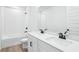 Modern bathroom featuring double sinks, quartz countertops, and a shower-tub combination at 1832 Draughton Dr, Zephyrhills, FL 33541