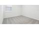 Bedroom showcasing neutral carpet, a bright window, and crisp white interior at 1832 Draughton Dr, Zephyrhills, FL 33541