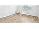 Bedroom featuring wood-style flooring, natural light from the window at 1832 Draughton Dr, Zephyrhills, FL 33541