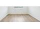 Well-lit bedroom showcasing wood-style flooring and a window at 1832 Draughton Dr, Zephyrhills, FL 33541