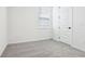 Bright bedroom featuring neutral carpet, natural light from the window, and crisp white interior at 1832 Draughton Dr, Zephyrhills, FL 33541