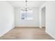 Dining room with tiled floors, modern chandelier, and light from the window at 1832 Draughton Dr, Zephyrhills, FL 33541
