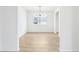 Dining room with tiled floors, modern chandelier, and light from the window at 1832 Draughton Dr, Zephyrhills, FL 33541