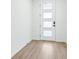 Bright entryway featuring wood-look tile flooring and a modern front door with frosted windows at 1832 Draughton Dr, Zephyrhills, FL 33541