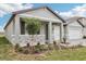 Charming one-story home featuring stone accents and a well-manicured front yard with lush plants at 1832 Draughton Dr, Zephyrhills, FL 33541