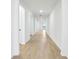 Bright hallway showcasing neutral paint and wood-look tile flooring throughout the home at 1832 Draughton Dr, Zephyrhills, FL 33541
