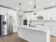 Eat-in kitchen features white cabinets, stainless appliances, and a large kitchen island at 1832 Draughton Dr, Zephyrhills, FL 33541