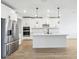 Modern eat-in kitchen with stainless appliances, white cabinets, and a large kitchen island at 1832 Draughton Dr, Zephyrhills, FL 33541