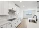 Bright eat-in kitchen featuring white cabinets and quartz countertops at 1832 Draughton Dr, Zephyrhills, FL 33541
