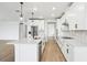 Eat-in kitchen featuring a large island, white cabinetry and stainless steel appliances at 1832 Draughton Dr, Zephyrhills, FL 33541