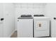 Clean and functional laundry room equipped with modern appliances, shelving, and a crisp white interior at 1832 Draughton Dr, Zephyrhills, FL 33541