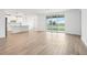 Bright, open living room with wood-look tile and sliding glass doors to the outside at 1832 Draughton Dr, Zephyrhills, FL 33541