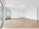 Open living room with wood-look tile floors and sliding glass doors to the outdoor space at 1832 Draughton Dr, Zephyrhills, FL 33541