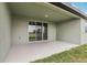 Spacious covered patio area with sliding glass doors and a view of the backyard at 1832 Draughton Dr, Zephyrhills, FL 33541